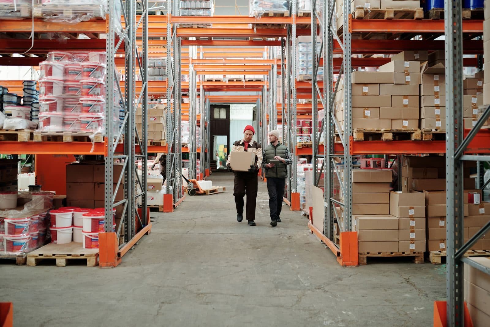 Interior de nave industrial con racks de almacenamiento y pasillo central